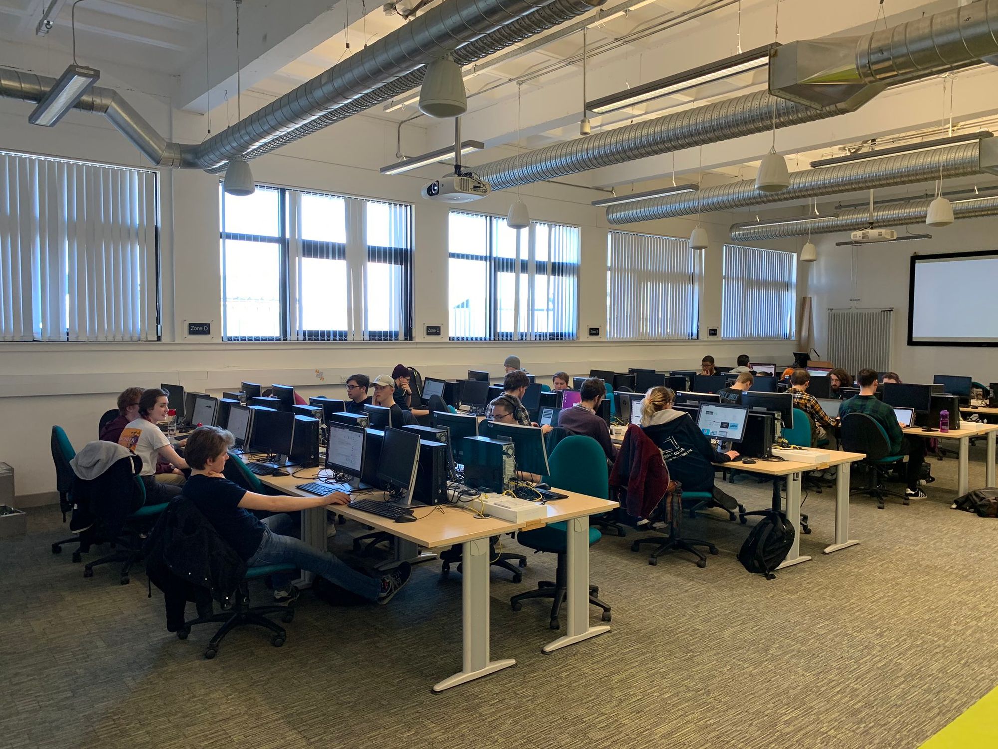 Room full of students sat at computers learning cyber security 