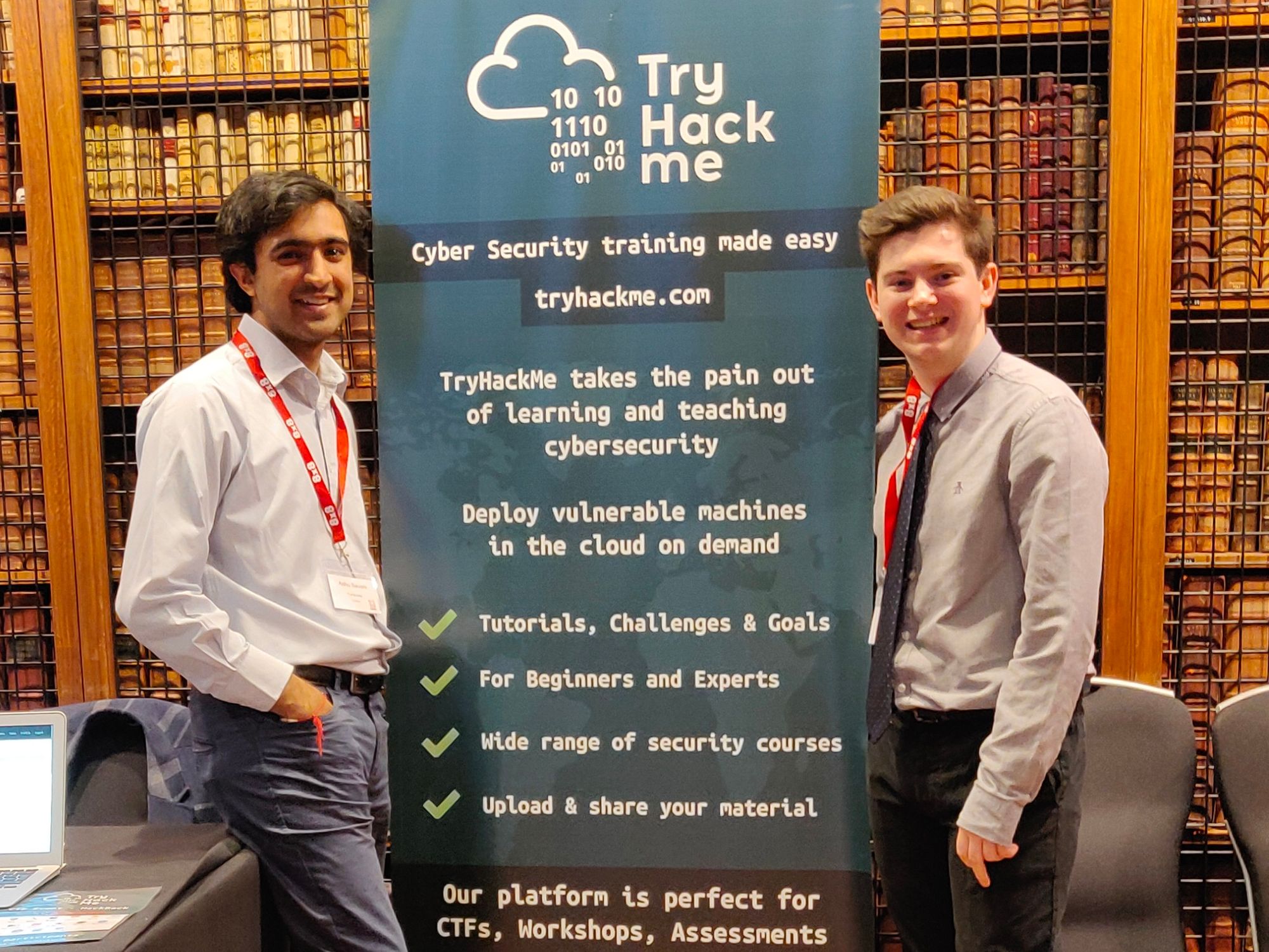 Ashu and Ben - TryHackMe co-founders with a TryHackMe sign